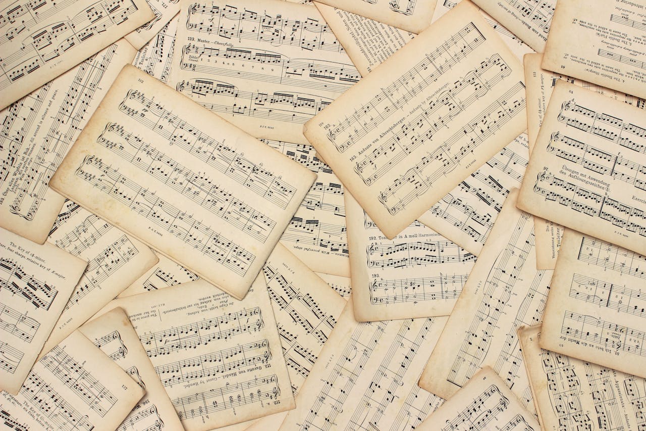 services-01 An artistic flat lay of vintage music sheets with a classic touch.